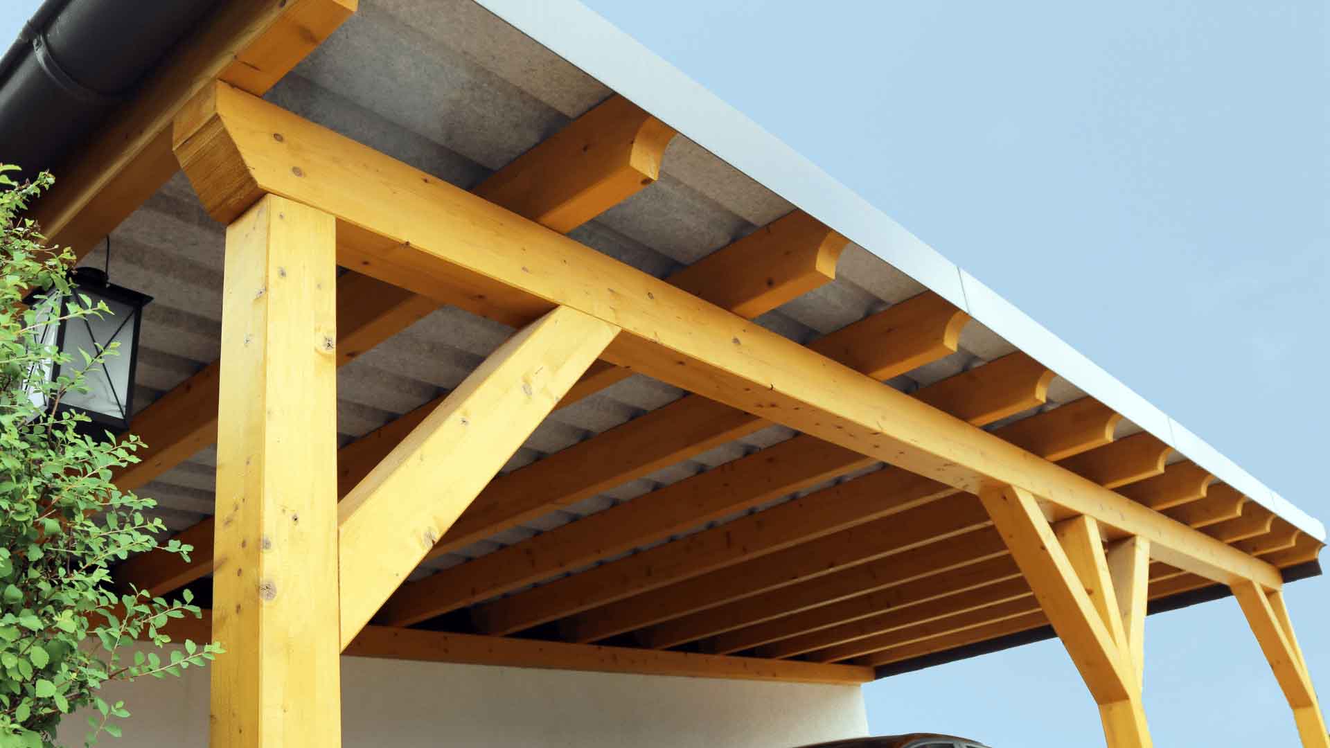 Timber-framed carport roof structure viewed from underneath