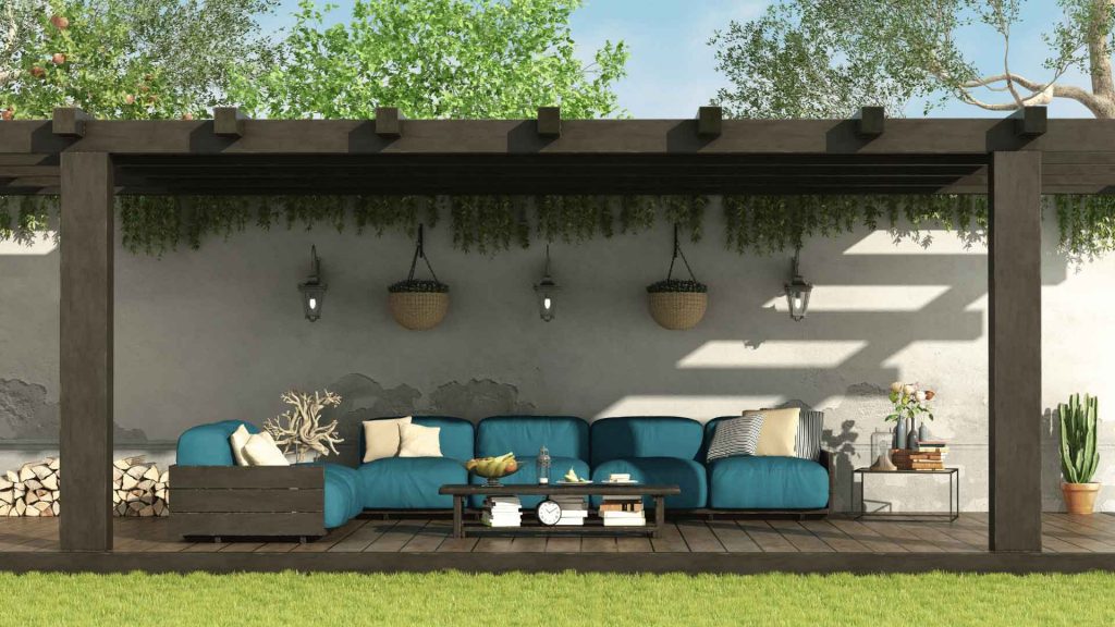 Outdoor patio lounge area with comfortable seating and hanging garden plants
