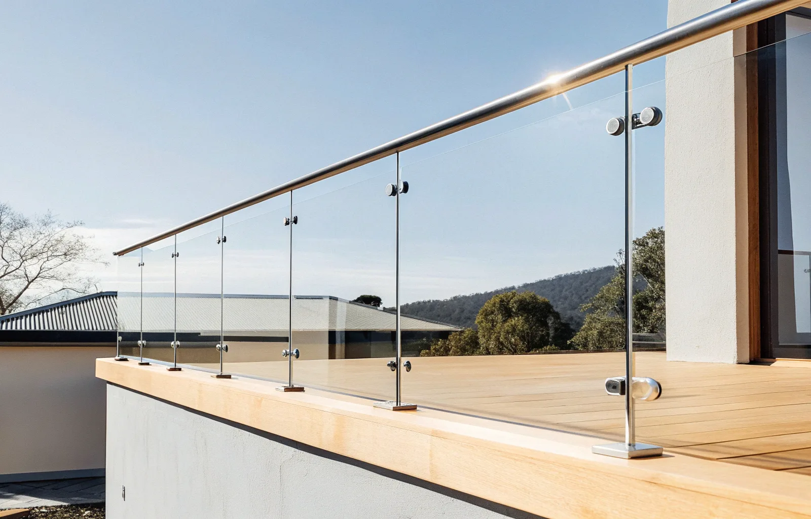 Modern glass balustrade with stainless steel handrail on an elevated timber deck